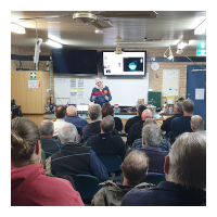 Image of members listening to one of the presenter at the meeting